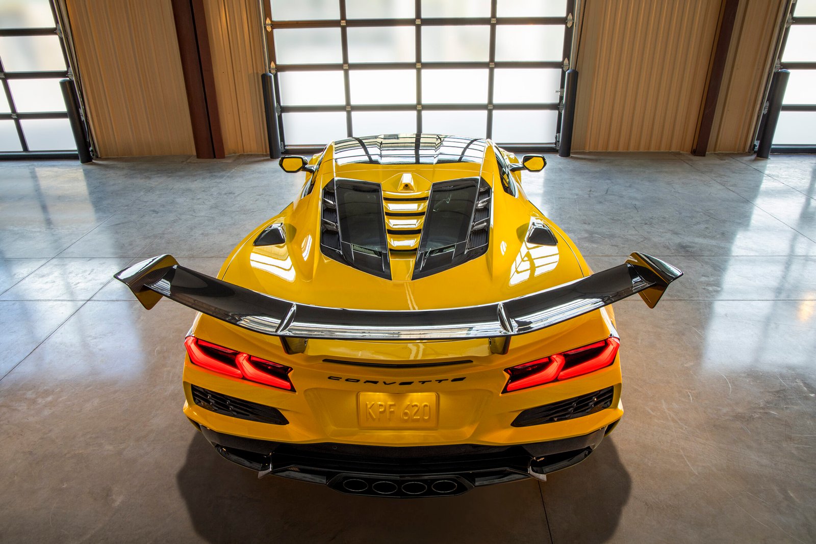 Rear view of Chevrolet Corvette ZR1 Coupe with ZTK Performance Package, highlighting the split-window rear hatch, parked in a garage. Preproduction model shown. Actual production model may vary.