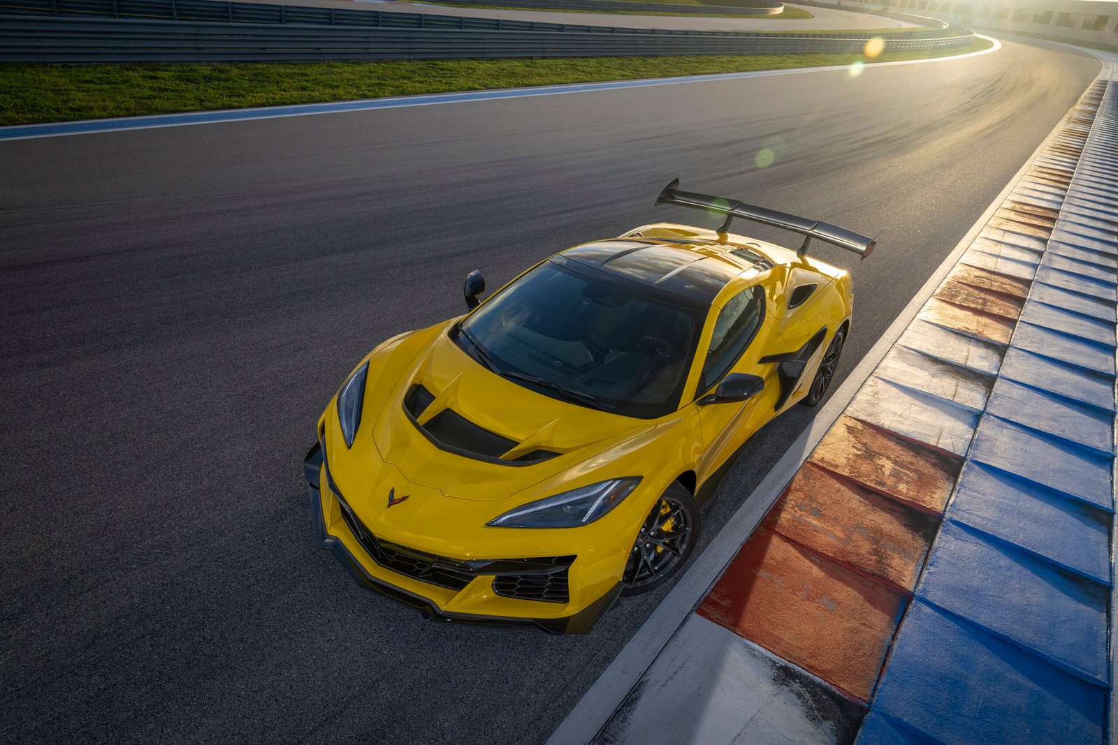 Front aerial shot of the Chevrolet Corvette ZR1 coupe in Competition Yellow with optional ZTK Performance Package on the race track. Preproduction model shown. Actual production model may vary.